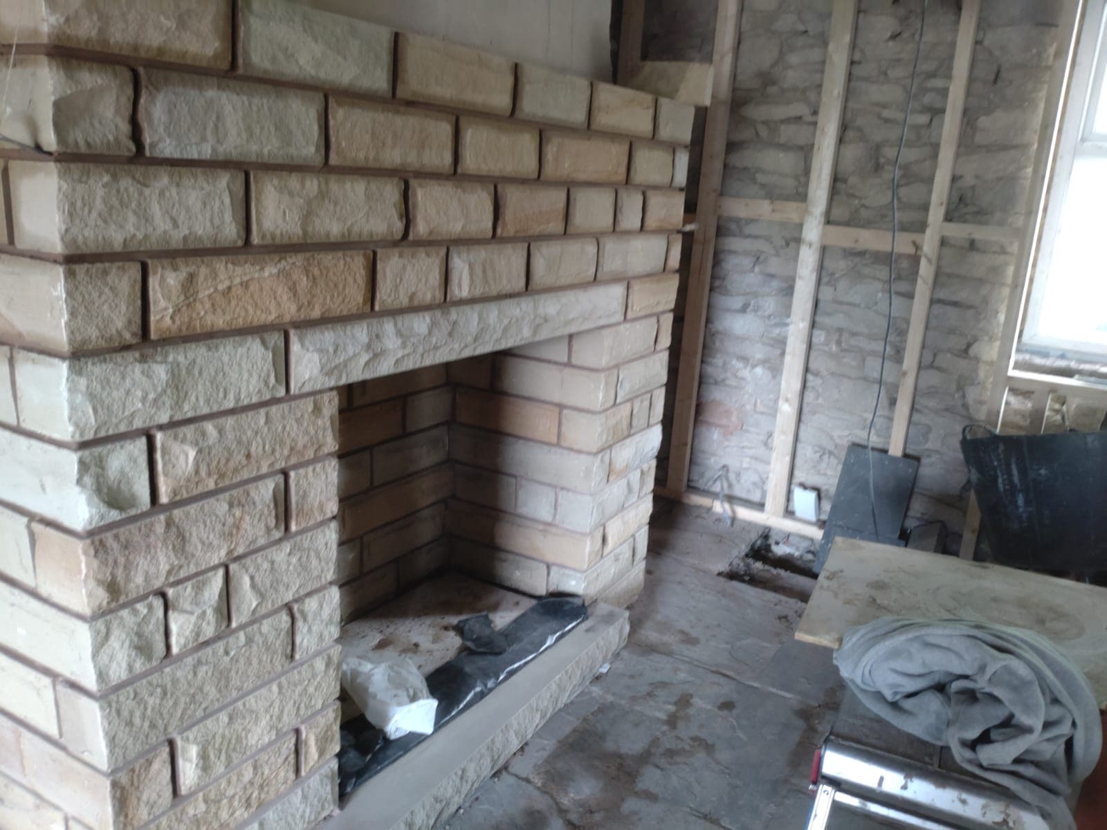 Hand-built sandstone interior fireplace, mid-build