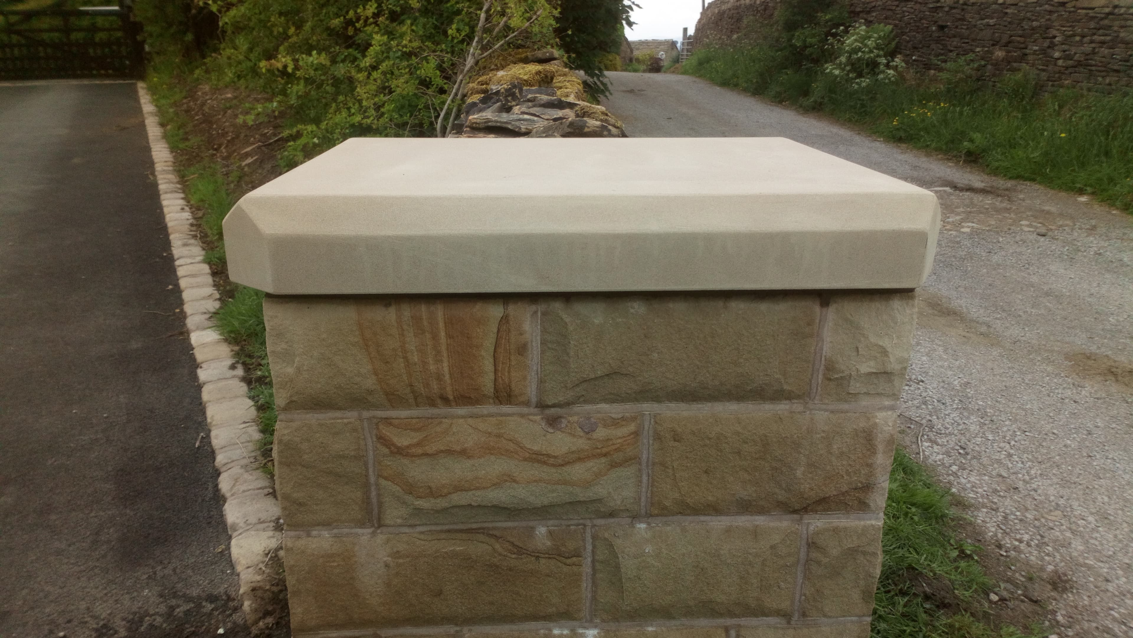 Close-up of the finished sandstone gatepost with shaped sandstone capstone