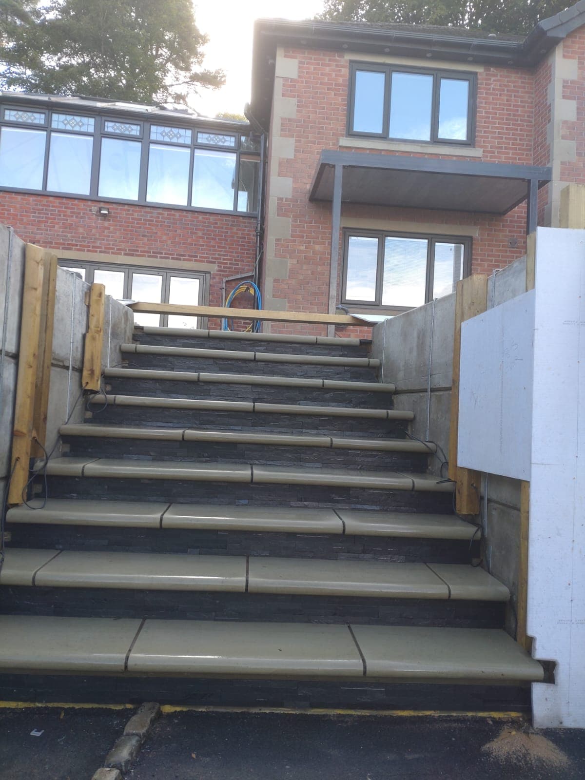 Slate-clad staircase mid-installation, timber props still in place